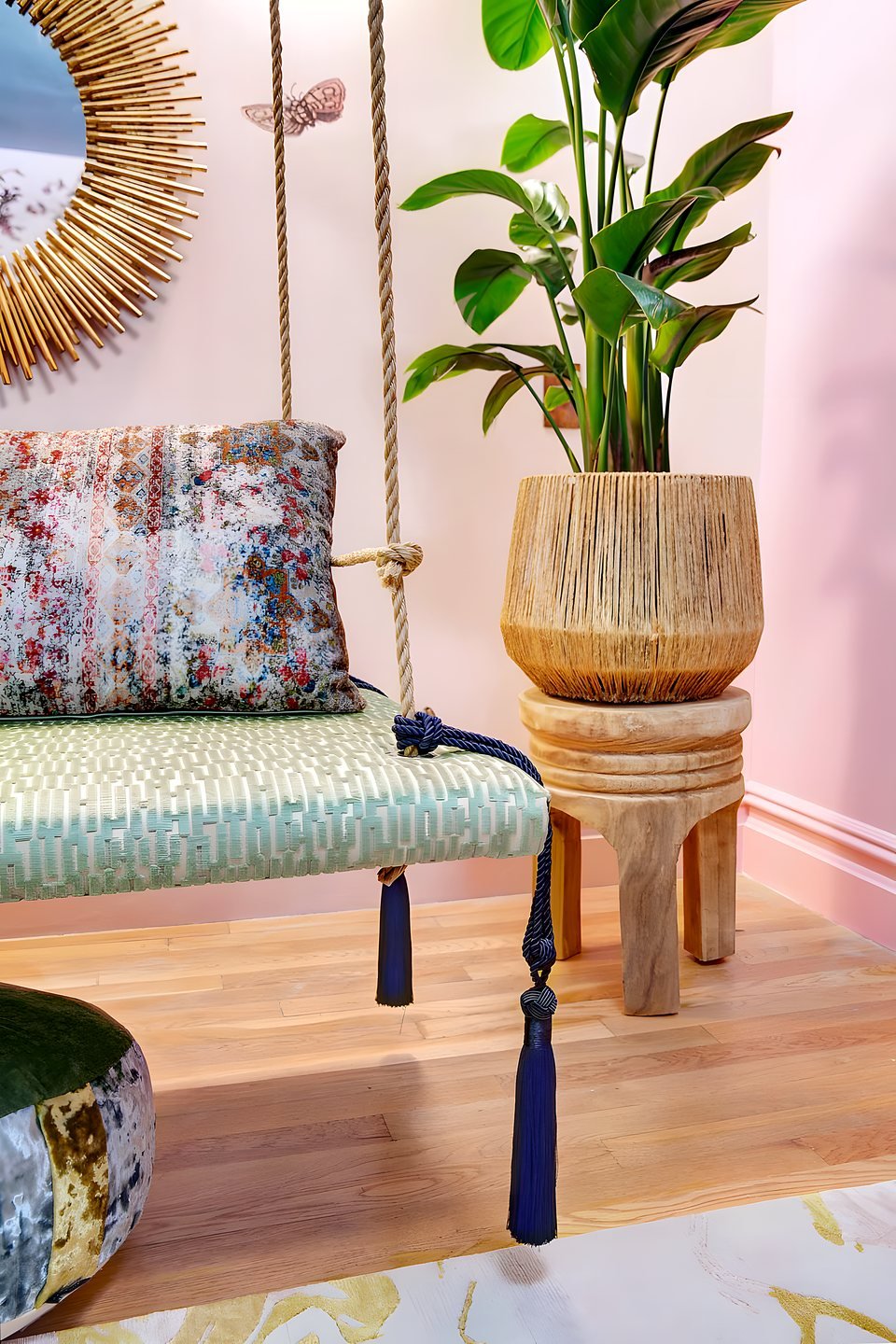 Chinoiserie sitting room with brass bamboo-dome lamps and curved navy velvet sofa
