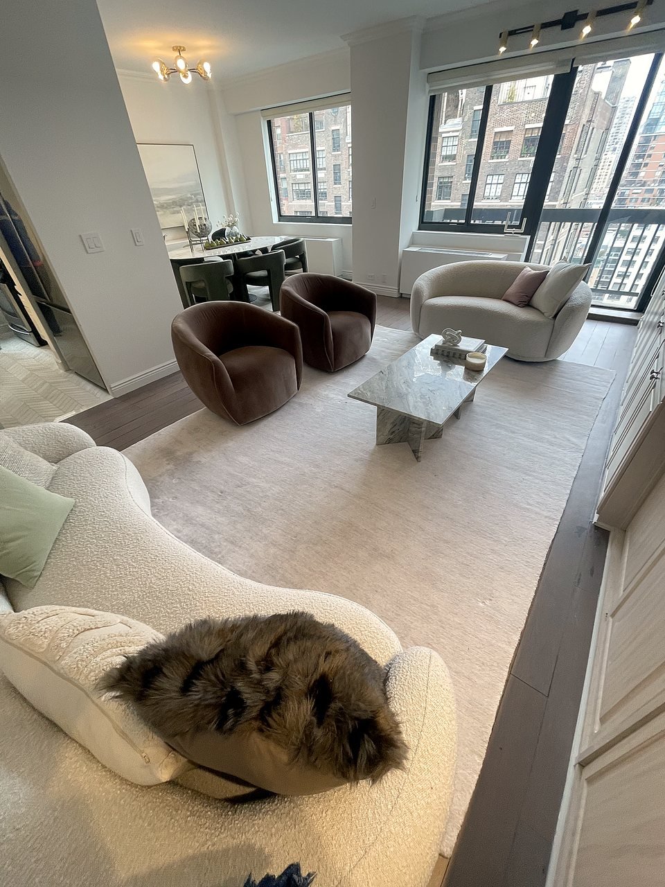Corner of the living room framed by the arched window and curved sofa